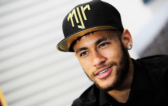 Neymar wearing a black cap with gold logo