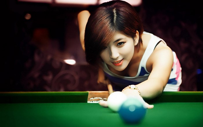 Woman playing billiards