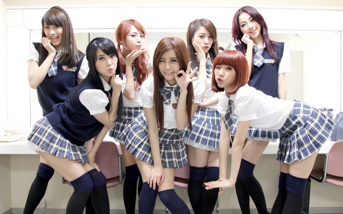 Group of young women in school uniforms posing