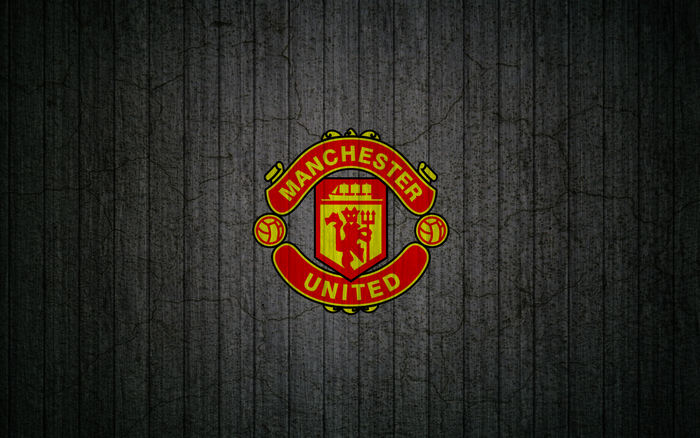 Manchester United logo on a dark textured background