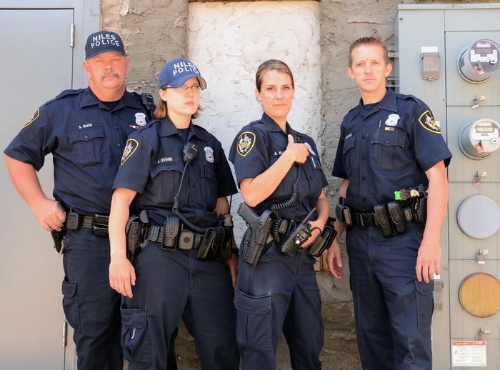 Four Niles Police officers standing outdoors