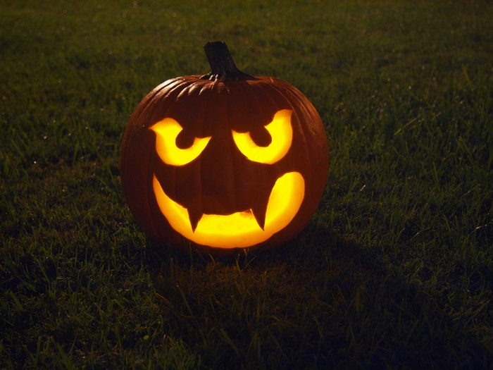 Jack-o'-lantern on grass at night