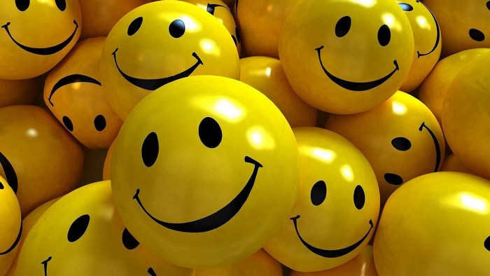 Pile of yellow smiley face balloons
