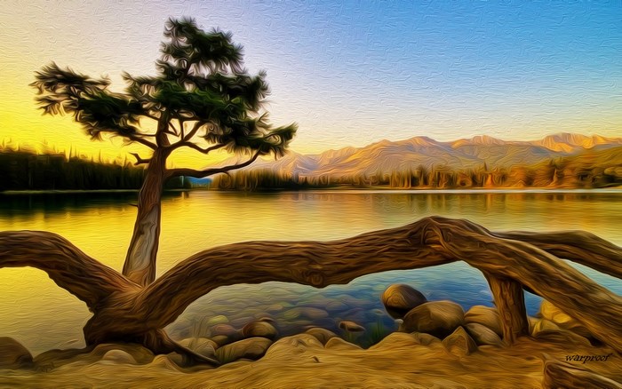 Lake and mountains at sunset with a tree