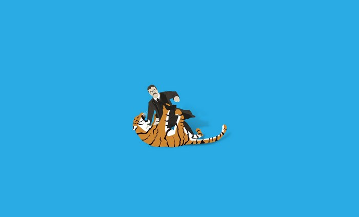 Man in suit wrestling a tiger