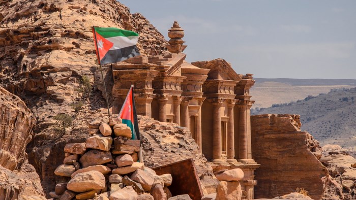 The Monastery in Petra, Jordan with Jordanian flags