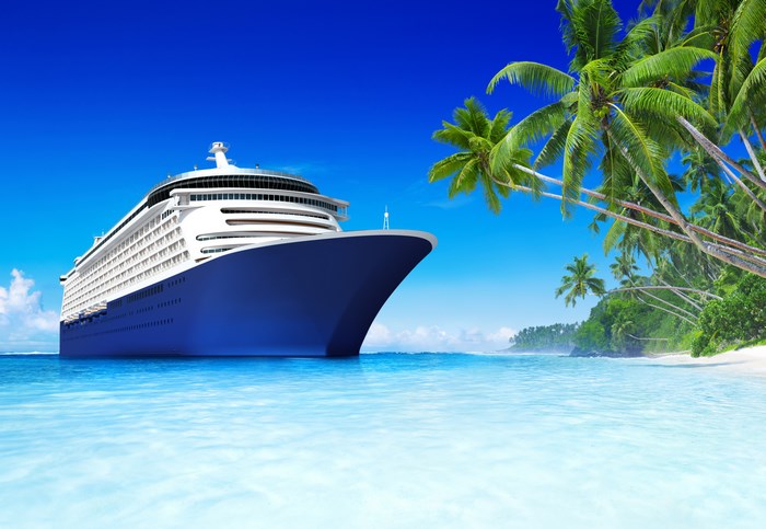 Cruise ship near a tropical island with palm trees