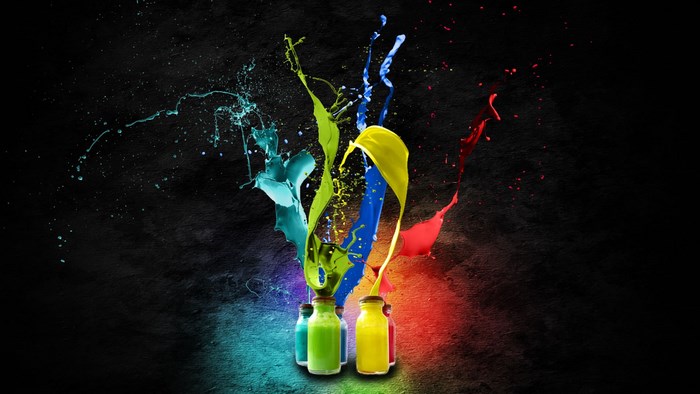 Paint Splashes from Bottles on Black Background