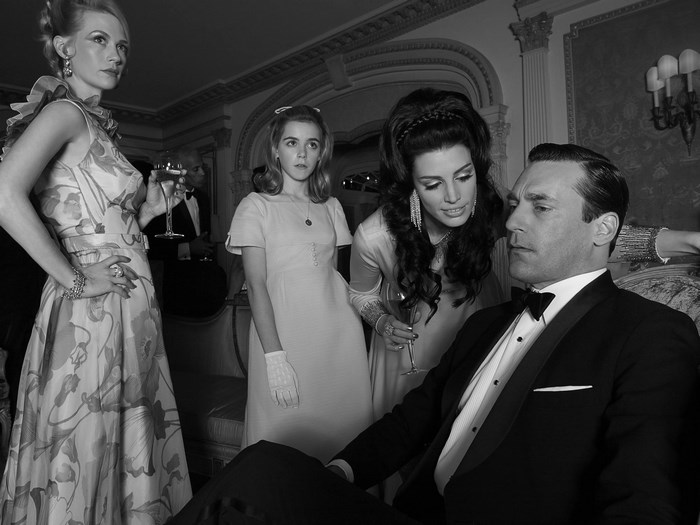 Don Draper with women in formal attire from Mad Men