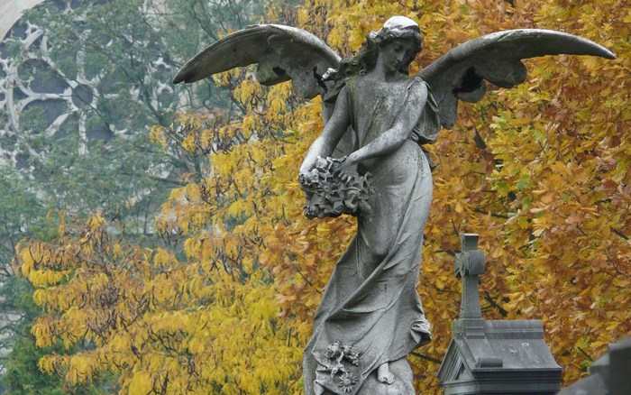 Angel statue holding flowers in a cemetery
