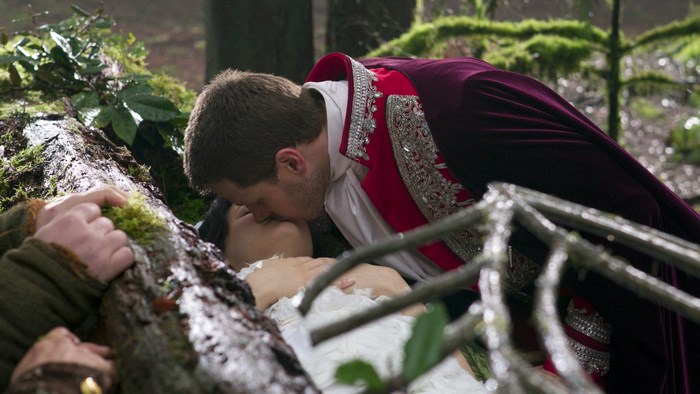 Snow White and Prince Charming kiss in forest