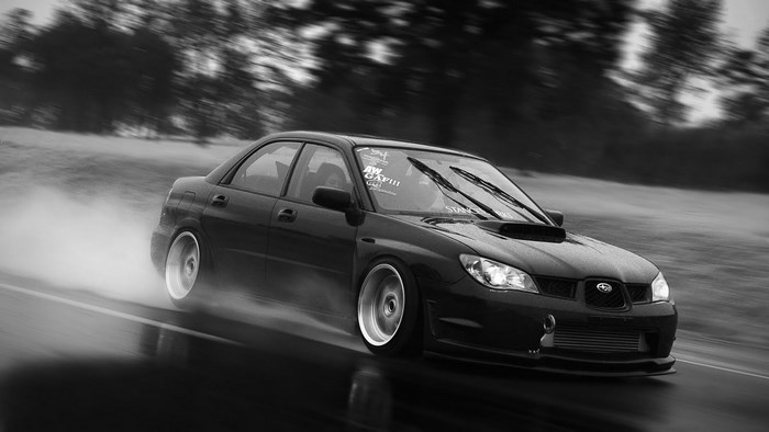 Black Subaru Impreza WRX STI drifting on wet road