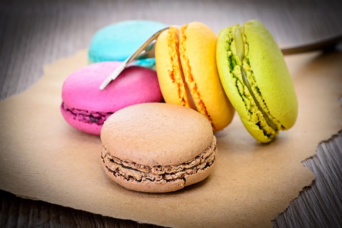 Colorful macarons on brown paper