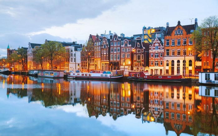 Amsterdam canal with historic buildings and houseboats