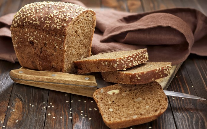 Loaf of bread with sesame seeds and slices
