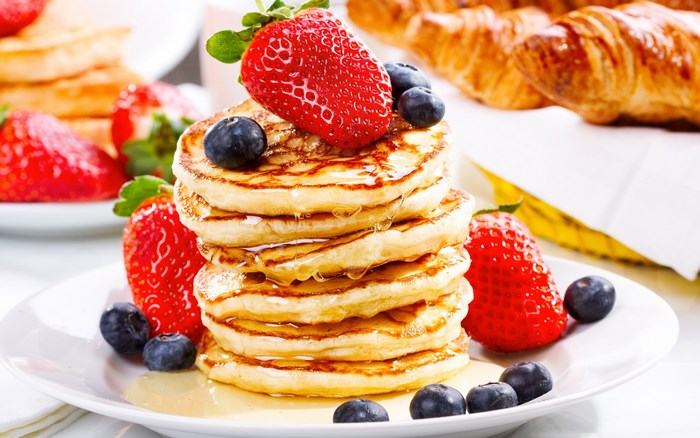 Stack of pancakes with strawberries and blueberries