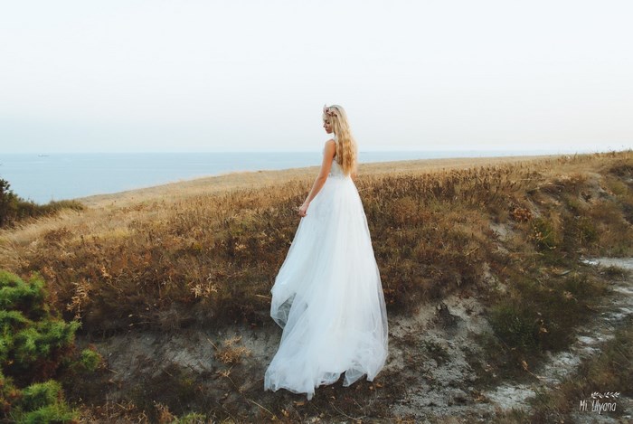Bride in White Dress on a Coastal Cliff