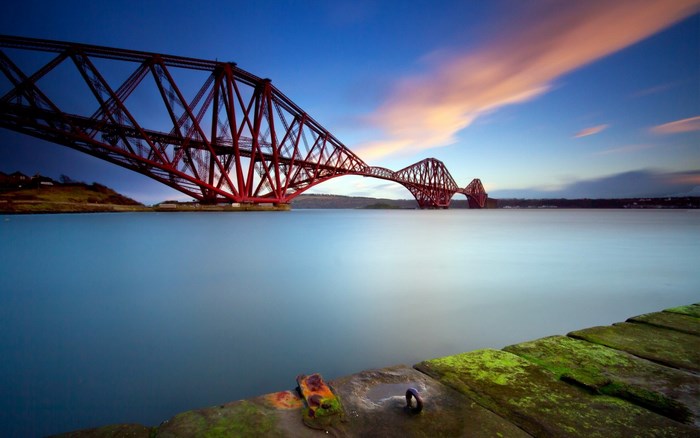 Forth Bridge over water at sunset