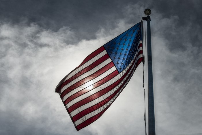 American Flag Waving Against Cloudy Sky