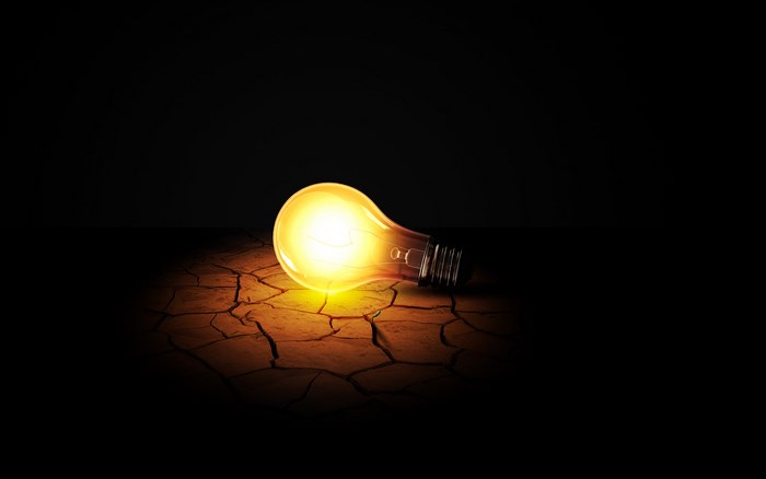 Light bulb on cracked ground