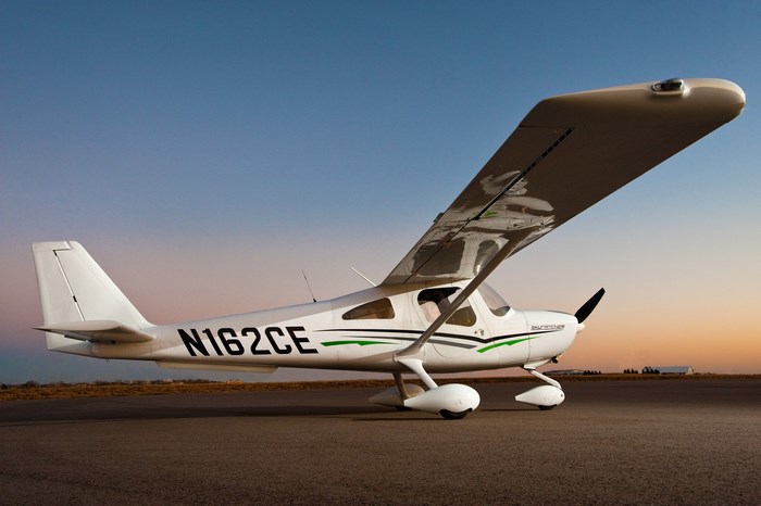 Cessna N162CE airplane on tarmac at sunset