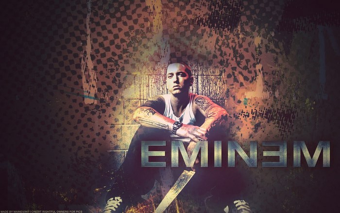 Eminem sitting in front of a textured wall