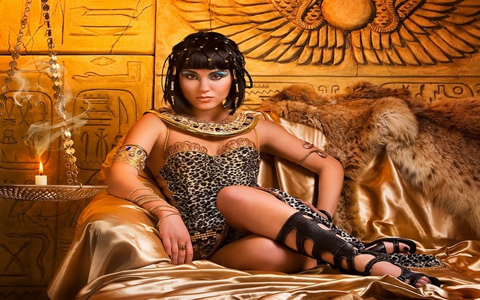 Woman dressed as Cleopatra in Egyptian-themed setting