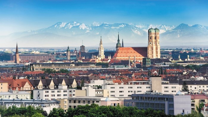 Munich cityscape with Frauenkirche and Alps