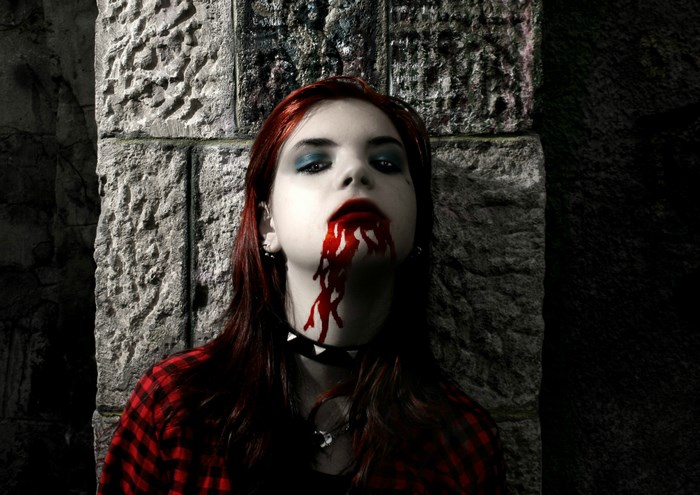 Vampire girl with blood dripping from mouth