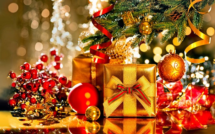 Christmas presents and ornaments under a tree