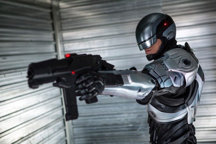 RoboCop from RoboCop 2014 holding a gun
