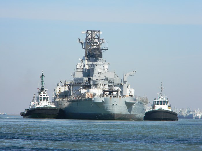 USS Iowa BB 61 battleship with tugboats