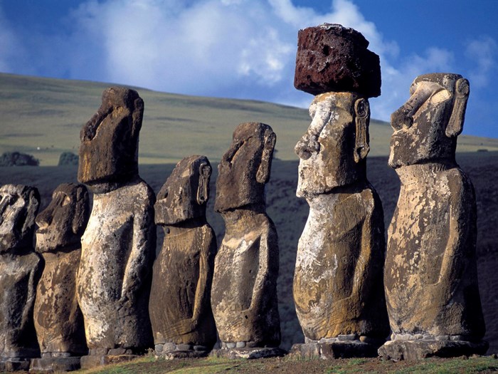 Moai statues on Easter Island with grassy hills