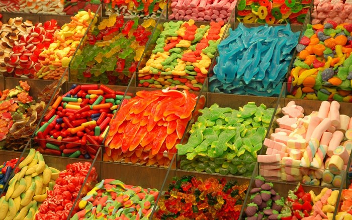 Assortment of colorful gummy candies in display bins