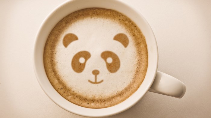 Panda face latte art in a white mug