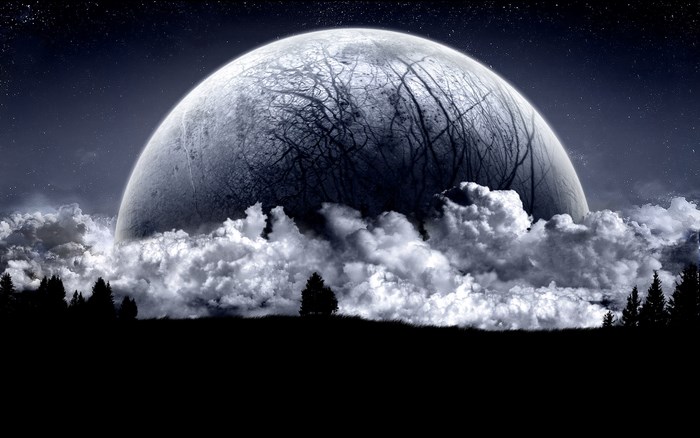 Planet rising over clouds with trees