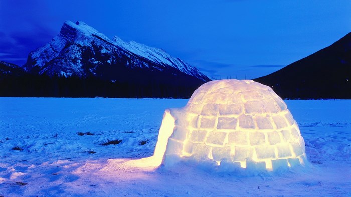 Igloo in a snowy landscape at dusk