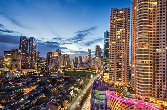 Jakarta skyline at dusk with skyscrapers and city lights