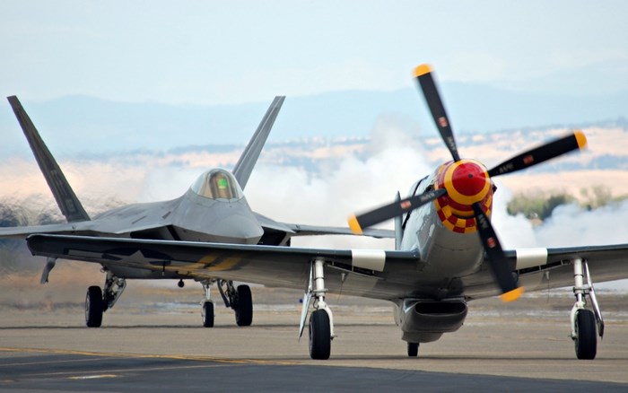 North American P-51 Mustang and F-22 Raptor on tarmac