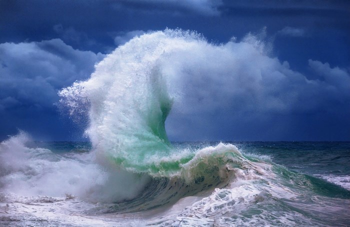 Crashing Ocean Wave Under Dark Clouds