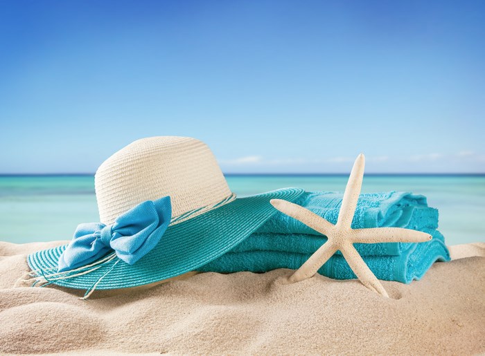 Beach scene with hat, towels, and starfish