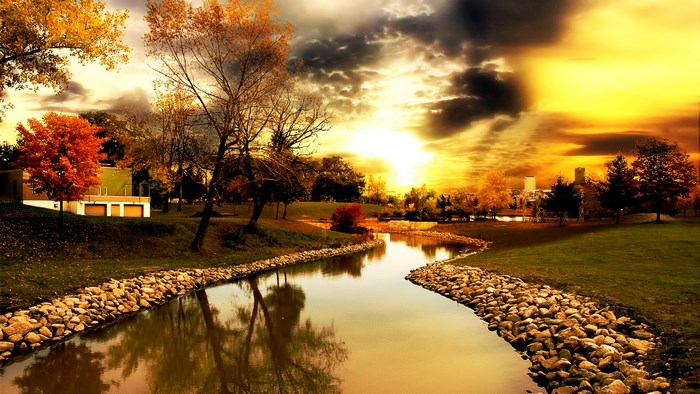 Scenic river and trees at sunset
