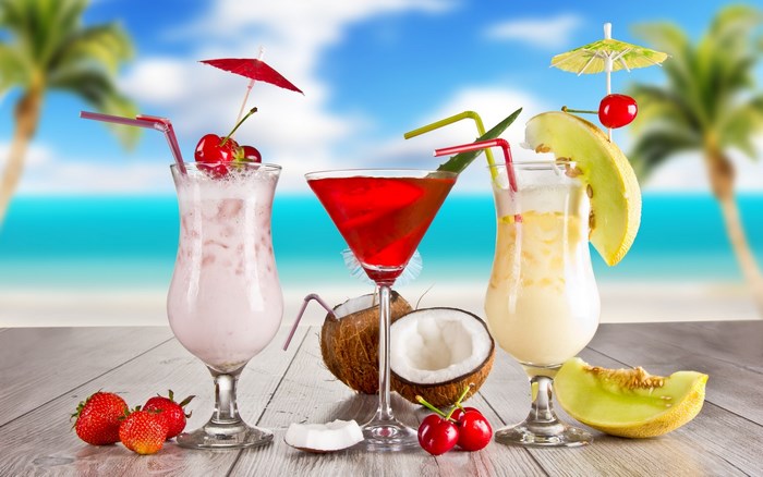 Tropical cocktails on a beach with palm trees