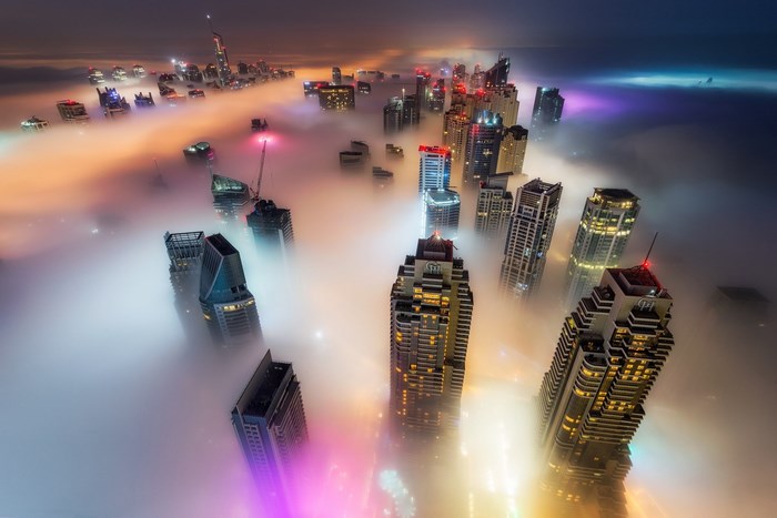 Dubai skyscrapers shrouded in fog at night