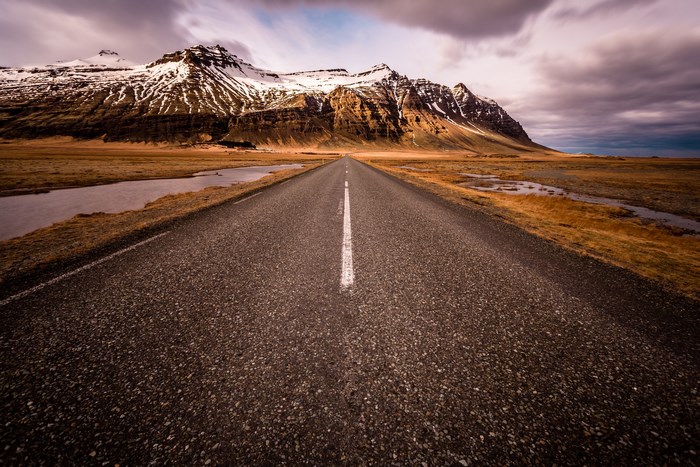 Road leading to snow-capped mountains