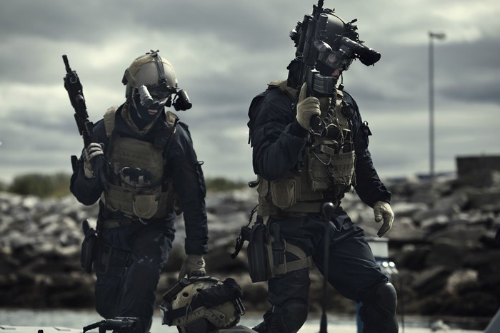 Two soldiers with rifles and tactical gear