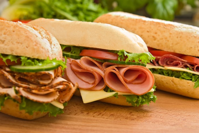 Three sandwiches with ham, turkey, and salami
