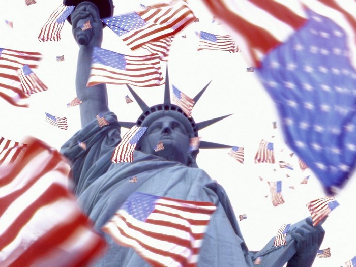 Statue of Liberty surrounded by American flags