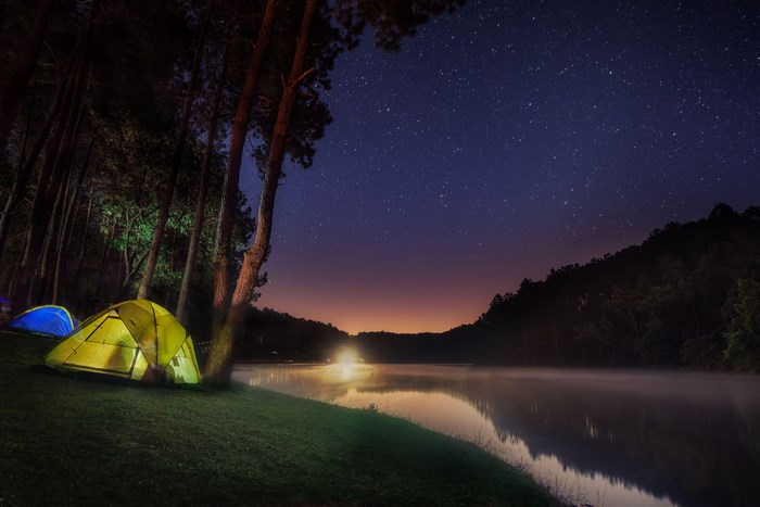 Camping by a lake under the stars