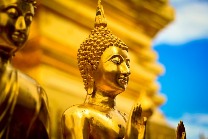 Golden Buddha Statues with Blue Sky